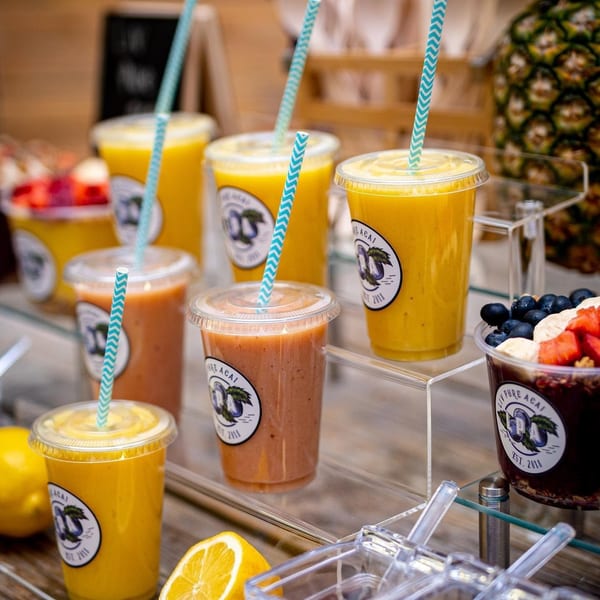 A display of smoothies and acai bowls from Liv Pure Acai, with fresh fruit and toppings.